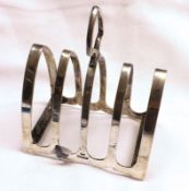 An Elizabeth II Four Slice Toast Rack or typical arched form, with ringlet handle, Sheffield 1952,