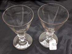 A pair of 19th Century Clear Tapering Rummer Glasses with knopped stems, raised on circular