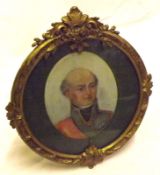 A small Framed Oval Picture of a military figure in a round brass easel backed frame with floral
