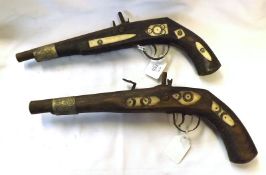 Two Vintage Oriental Flintlock Pistols, metal mounted barrels, 6 ¾” and 7”, 14 ¼” overall (A/F)