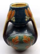 A Large unmarked Three-Handled Floor Vase, decorated with floral design in the Arts & Crafts
