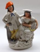 A Staffordshire Figure Group of a fisher couple on round plinth base (hairline crack to man’s