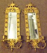 A pair of early 20th Century Brass Combination Wall Mirrors and Candelabra, with pierced frames with
