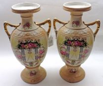 A pair of early 20th Century two-handled Baluster Vases, each decorated in colours with geometric