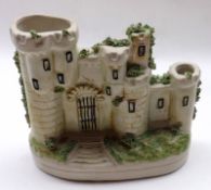 A small Staffordshire Pastille Burner, modelled as a castle, with moss detail, raised on oval plinth