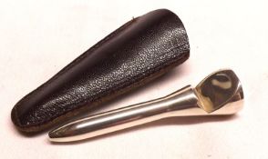 A 20th Century Novelty Bottle Opener in the form of a golf tee, in leather case, apparently