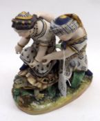 An unusual late 19th Century Continental Porcelain Figure Group of two figures riding a tortoise (