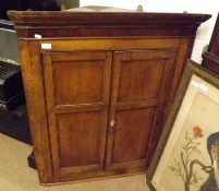 A 19th Century Oak Corner Cabinet with moulded cornice, two panelled doors and shelved interior, 32”