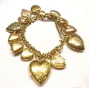 An interesting yellow metal Double Curb Link Bracelet, suspending numerous yellow metal and gold