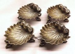 A Set of Four Victorian Small Shell-shaped Salts, raised on three serpent-shaped feet, apparently