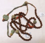 An interesting Ethnic Long Coquilla Nut Bead Necklace with jade-type pierced ceramic spherical