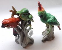 A Mixed Lot comprising: two Continental Coloured Parrot Ornaments on tree stump bases, unmarked,