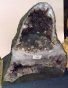 A Large Cut Amethyst Sample polished to a point, 16” high