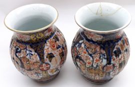 A pair of 19th Century Japanese Imari Baluster Vases, or ribbed circular form, painted in typical