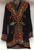 A 1960s Black Crushed Velvet Hooded Tunic, decorated with gold, red and turquoise embroidery,