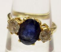 A hallmarked 18ct Gold Centre Large Oval Sapphire and two Brilliant Cut Diamond Ring, the sapphire