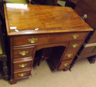 An 18th Century style Mahogany Kneehole Desk, crossbanded top with moulded edge over a full width