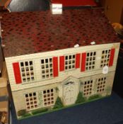 A Two-Storey Tinplate Lithographed Doll’s House, height 19”, length 22”, depth 12” (A/F)
