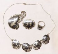 A group of Siamese white metal/niello work Jewellery, including two Brooches and a four-panel