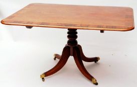 A Regency Period Mahogany and Rosewood Crossbanded Rectangular Tilt Top Dining Table, with moulded