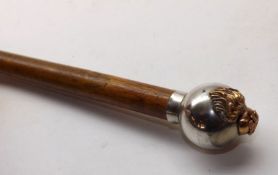 A Vintage Walking Stick with button top and military crest, 36” long