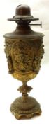 An unusual 19th Century Brass Oil Lamp Base, decorated with classical style figures and masks, 11”