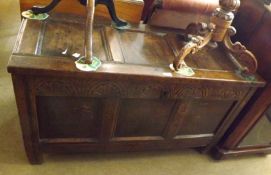 An 18th Century Oak Coffer, of typical form, three panelled top, void interior, the front with three