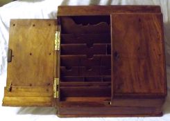 An early 20th Century Mahogany Stationery Cupboard with sloping front and two doors enclosing a