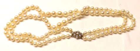 A double strand of Graduated Cultured Pearls with hallmarked 9ct Gold Pearl-set Clasp, 84cm long,