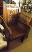 A Victorian Carved Oak Hall Chair, the back with central panel carved with spray of flowers, the