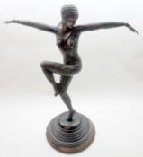 A 20th Century hollow metal Bronzed Figure of a dancing lady in Art Deco style dress, raised on a