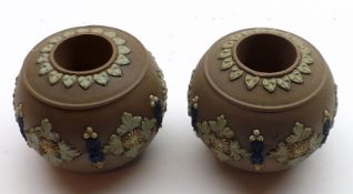 A pair of Royal Doulton Silicon Ware Vesta Stands of round form, decorated with blue and green
