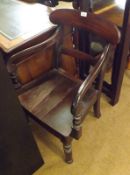 A 19th Century Mahogany Hard Seated Carver Chair with scroll arms, raised on turned front legs,