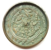 An Oriental Bronze Circular Medallion, embossed with cranes, foliage and central turtle, 4 ½”