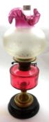 A late Victorian Oil Lamp with clear glass chimney, frilled frosted glass shade, ruby glass font (