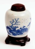 A Chinese Ginger Jar, decorated in underglaze blue with a river scene, with treen cover and stand,