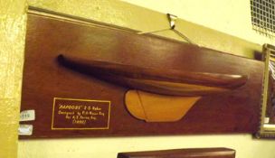 A Wooden Plaque with model of Yacht Papoose 2.5 Rater designed by P A Ralli Esq for A E Payne Esq