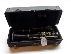 An early 20th Century Two Piece Simple System Ebony Clarinet, in key Eb, stamped with maker’s