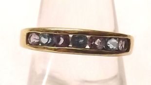 A hallmarked 9ct Gold Half Hoop Ring, channel set with seven Purple and Blue Stones