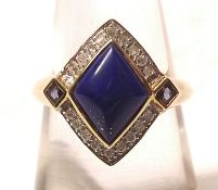 A hallmarked 9ct Gold Ring of navette shape, featuring a centre Lapis Lazuli surrounded by small