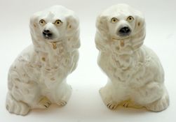 A small pair of 19th Century Staffordshire Model spaniels, of typical form, decorated in colours