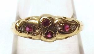 An 18ct Gold hallmarked Ring set with red stones and small Diamonds
