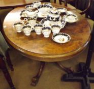 A Victorian Burr Walnut Veneered Loo Table, of typical form with oval top, raised on a four column