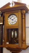 A Modern Amateur Built Oak Cased Wall Clock, the break arch pediment with cast brass finial over