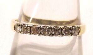 An unmarked yellow metal Half Hoop Ring, set with seven small Brilliant Cut Diamonds