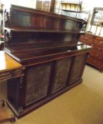 A Victorian Rosewood Chiffonier, the back with two narrow shelves, the body with three doors inset