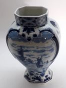 A 20th Century Delft Vase (lacking lid), typically decorated with blue panels of canal scene and