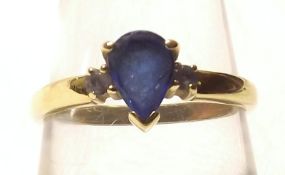 A hallmarked 18ct Gold pear-shaped Mid-Blue Sapphire Ring, featuring two further small Circular