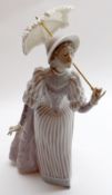 A large Lladro Figurine of lady in striped dress with parasol, No E18N to base, 11” high