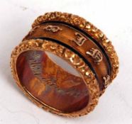 An early 19th Century Gold Mourning Ring, with chased foliate edges, raised lettering and black